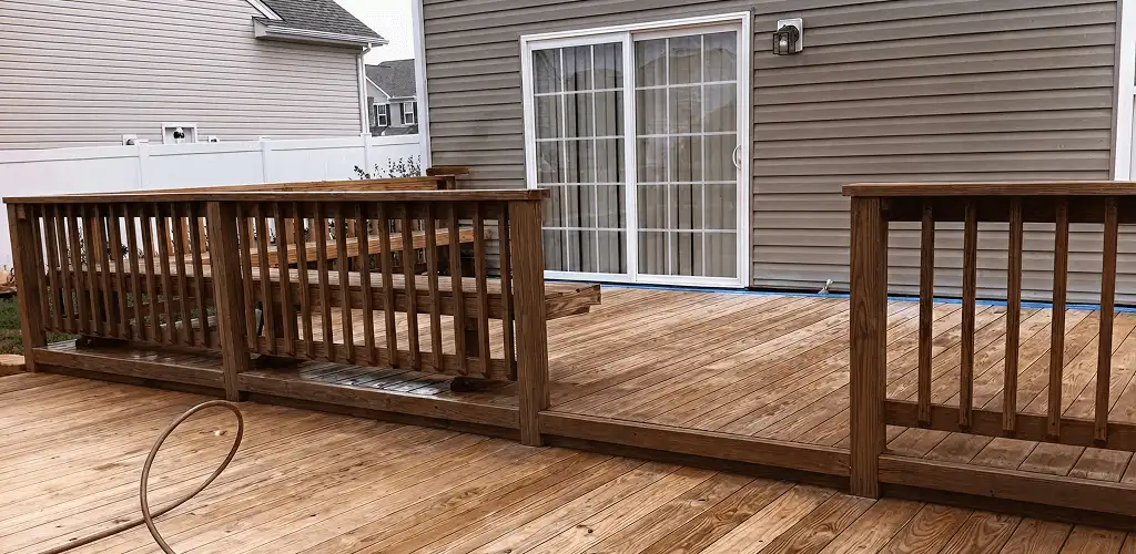 Deck sealing service protecting a backyard wood deck and railings in Saint Louis, MO