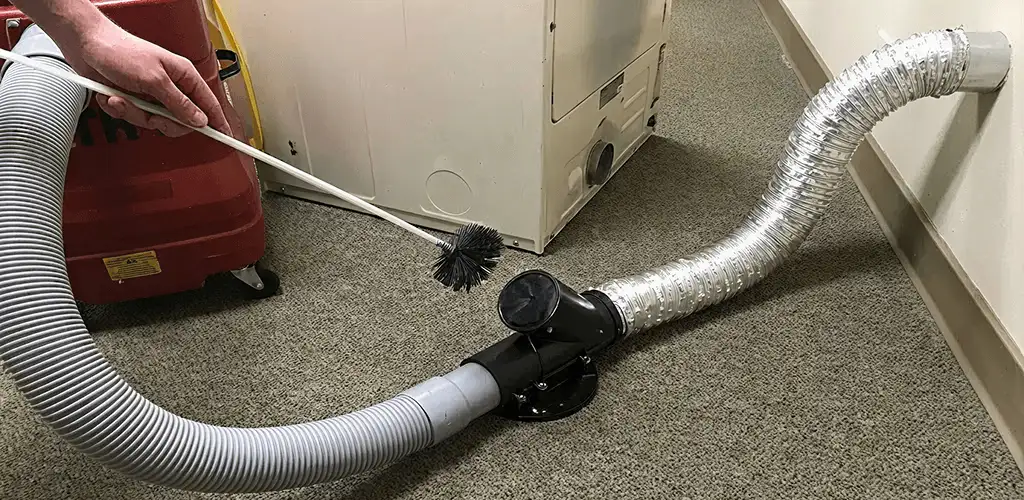 Dryer vent cleaning service removing lint from a dryer duct connection in Saint Louis, MO