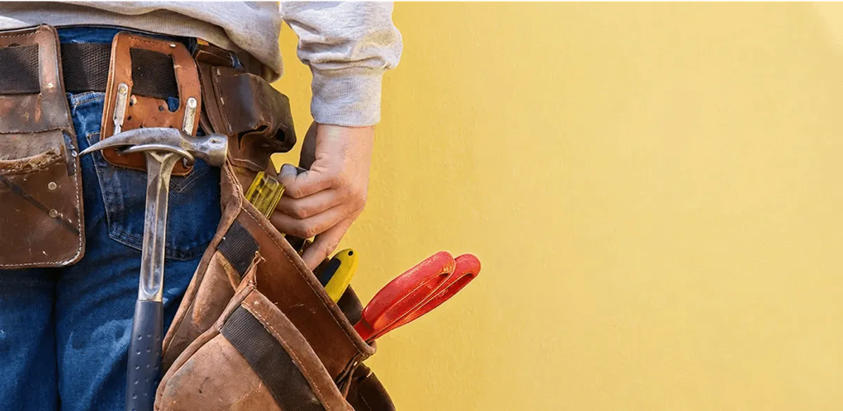 Handyman with tool belt ready for home repairs and maintenance in Saint Louis, MO