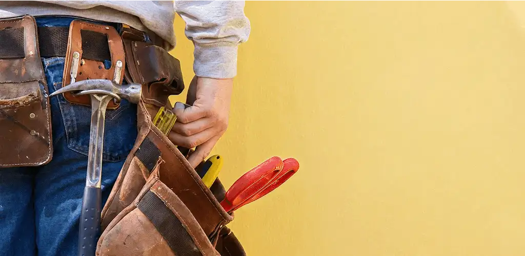 Handyman with tool belt ready for home repairs and maintenance in Saint Louis, MO