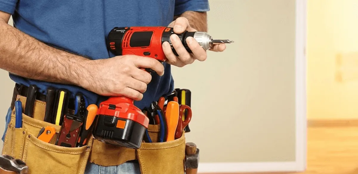 Handyman holding a power drill for home repairs and installations in Saint Louis, MO