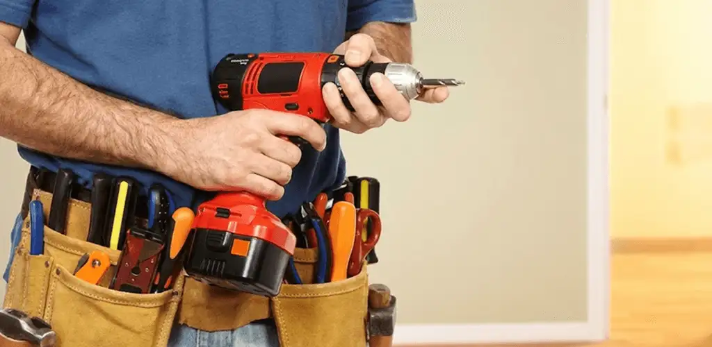 Handyman holding a power drill for home repairs and installations in Saint Louis, MO