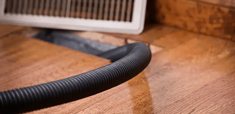 Air duct cleaning hose inserted into a floor vent for ductwork cleaning in Saint Louis, MO