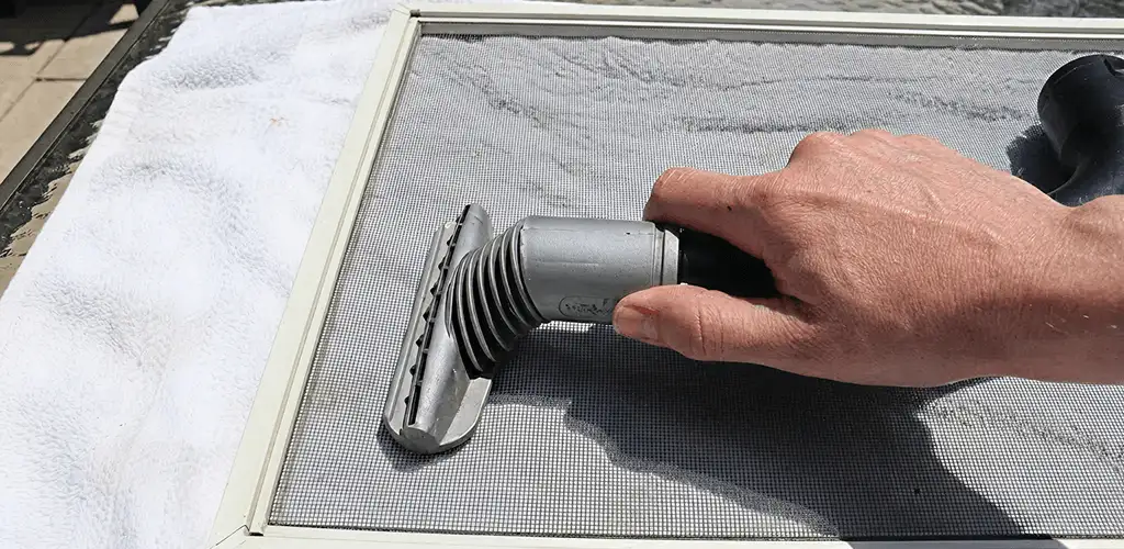 Window screen repair cleaning and fixing a damaged screen mesh in Saint Louis, MO